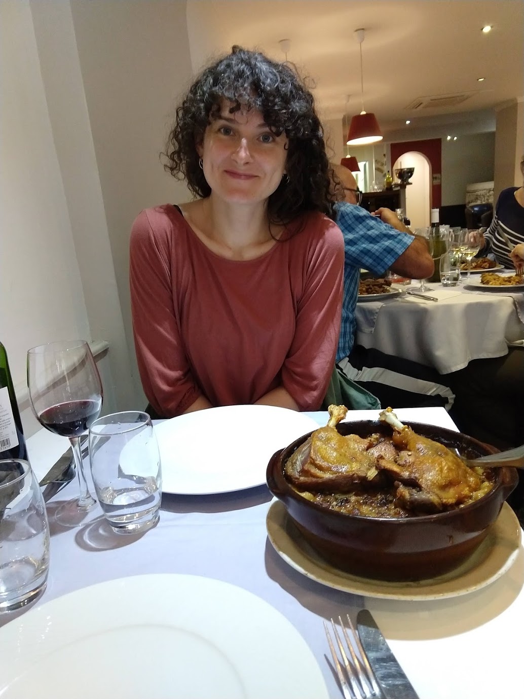 This is the face of someone who feels she fully deserves the cassoulet featuring duck confit that she is about to eat.